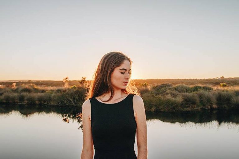 woman standing against the water