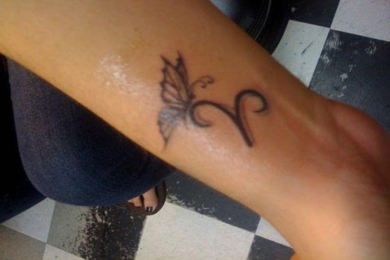 Aries symbol tattoo design with butterfly on arm