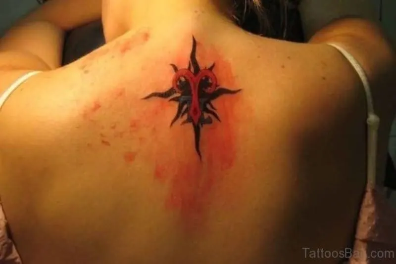 Aries symbol tattoo on the upper back