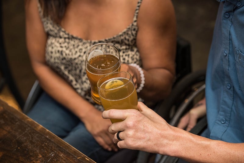 man and woman holding drinking glasses and toasting
