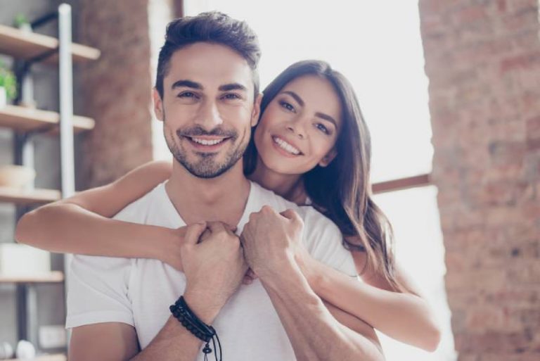 portrait of lovely couple smiling at home