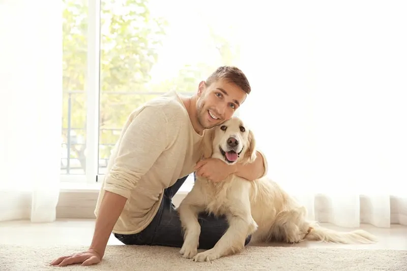 Handsome man with his dog in broad daylight
