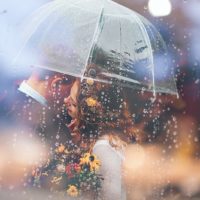 woman hugging man under clear umbrella