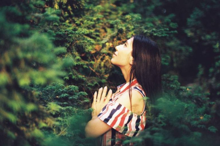 woman praying to god in nature