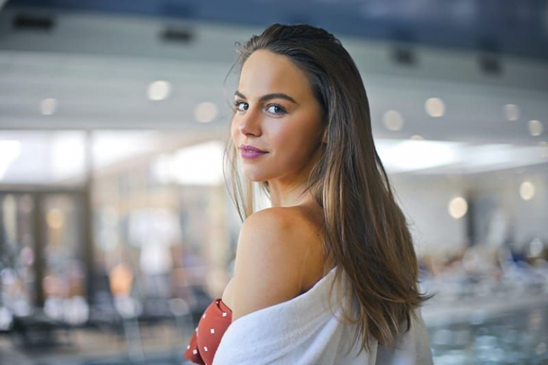 woman with long hair looking back