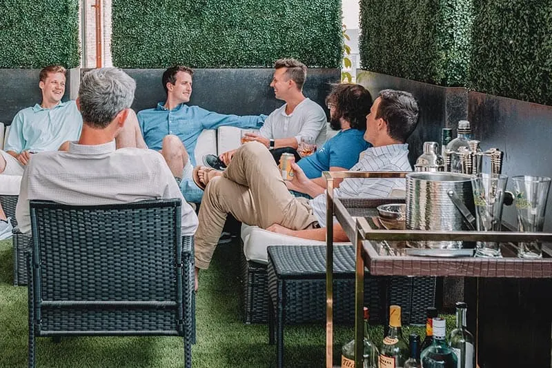 Men hanging out and laughing at the patio