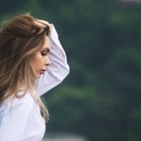 worried attractive woman holding her hair