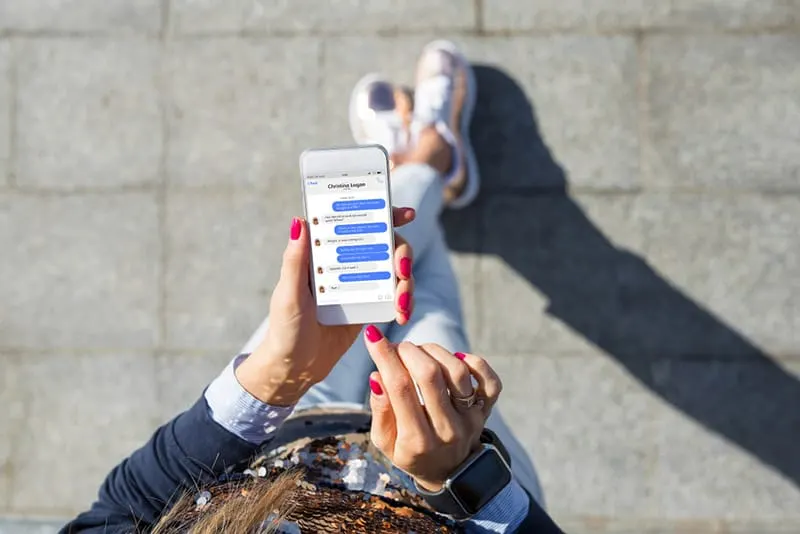 Top view of phone messages while person is walking