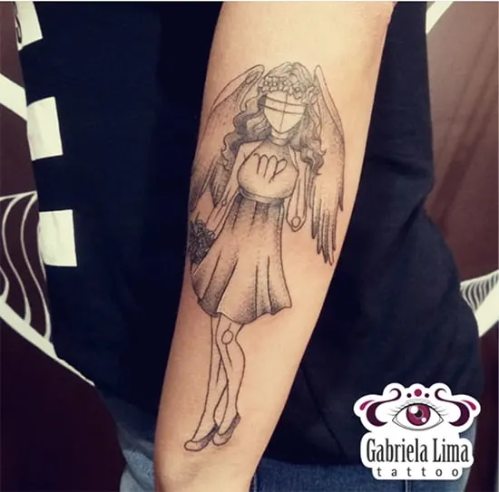 Virgo girl with wings tattoo on the arm