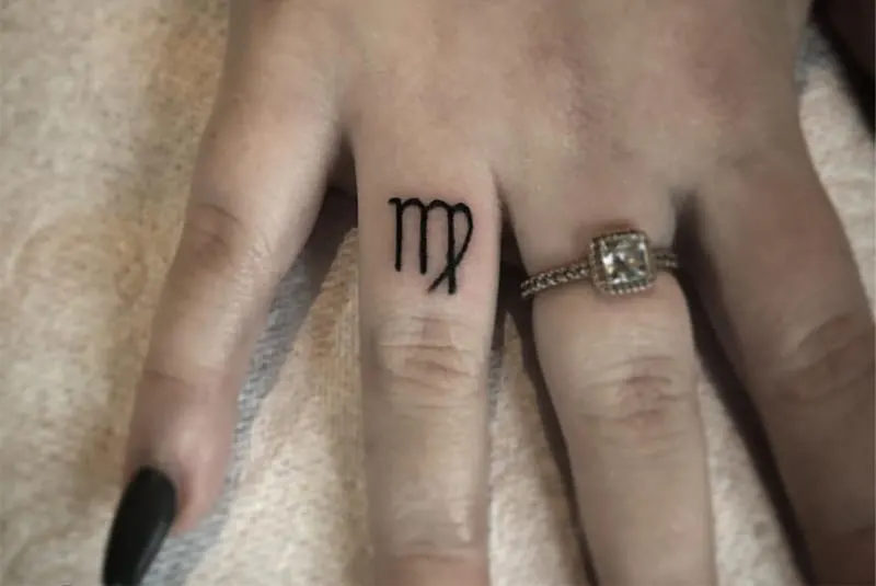 Virgo sign tattoo on the finger