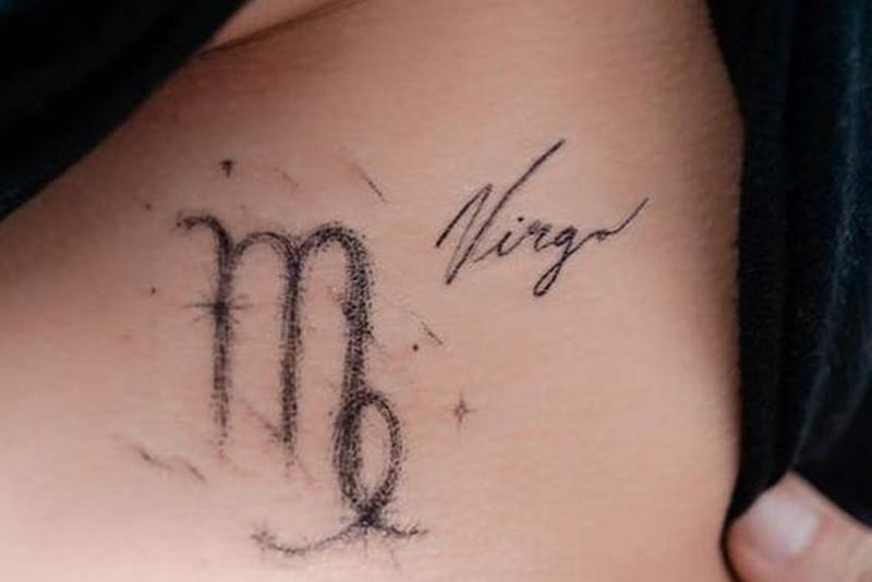 Virgo symbol in a brush stroke style tattoo with letters