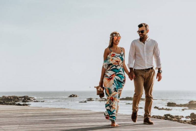 romantic couple walking on the beach