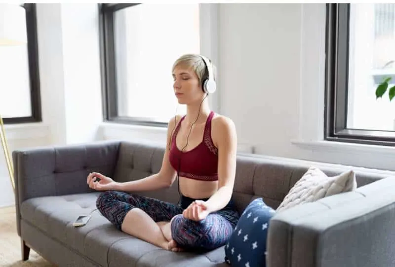 Woman listening to a meditation app as part of her morning mindfulness routine