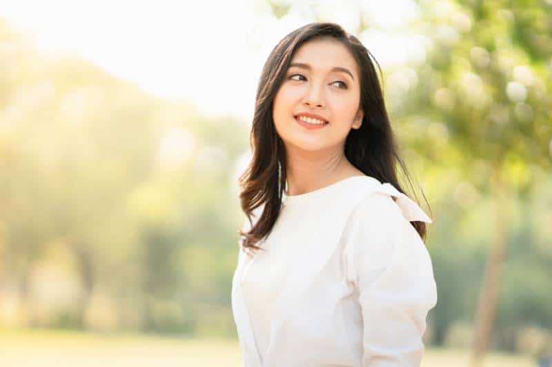 Mujer con camisa blanca informal al aire libre