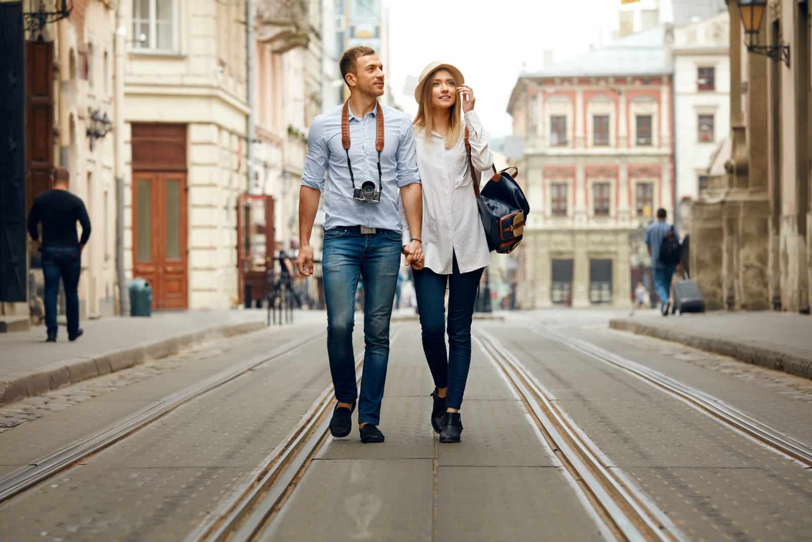 a couple in love holding hands and walking down the street