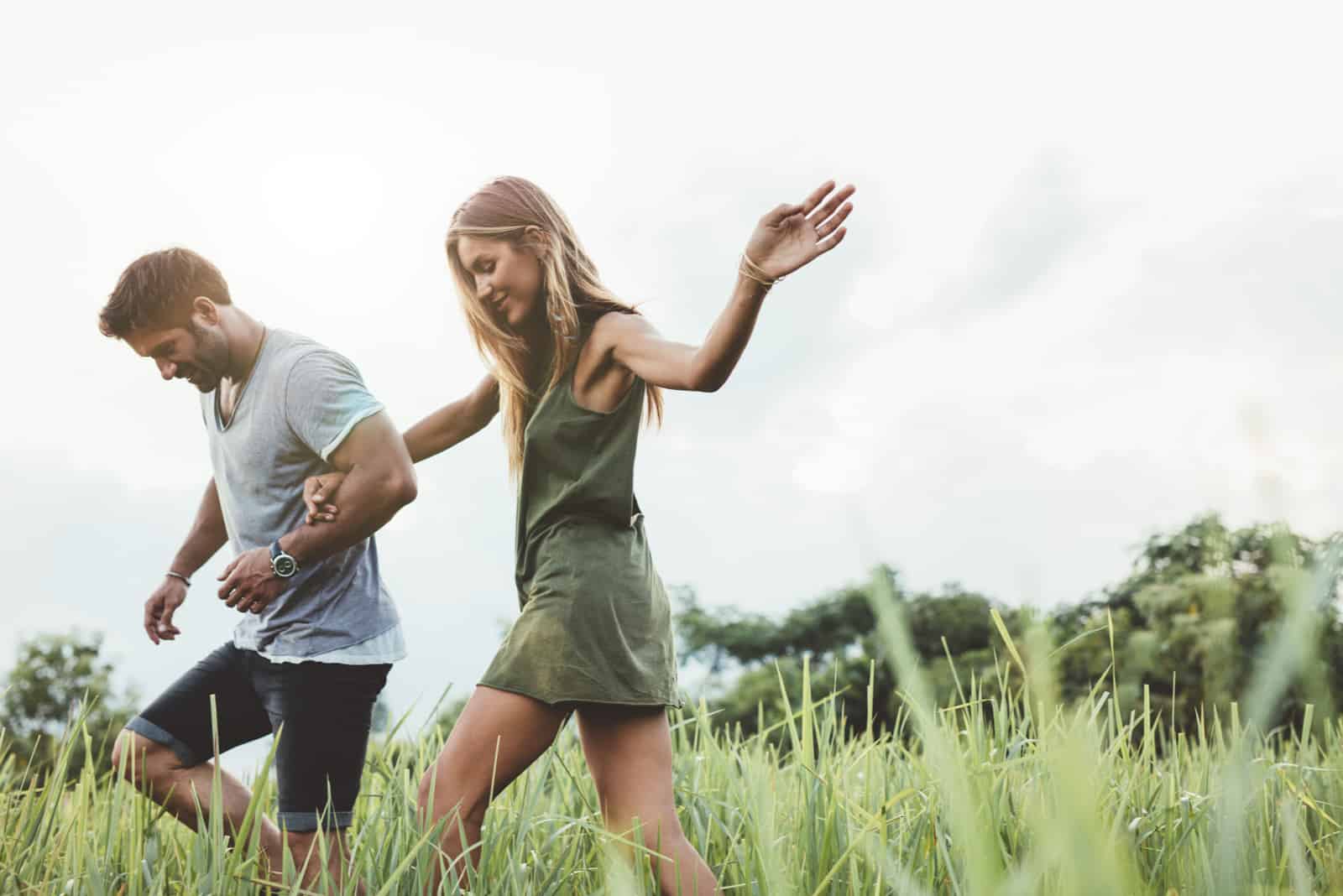 a couple in love sets in a field