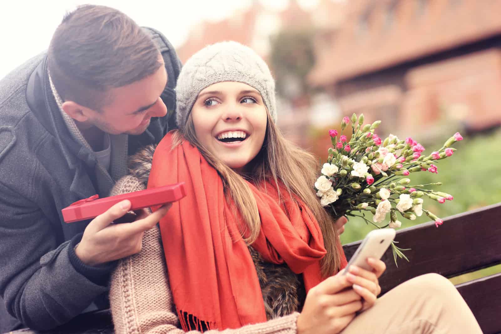 a man surprised a woman with a bouquet of roses