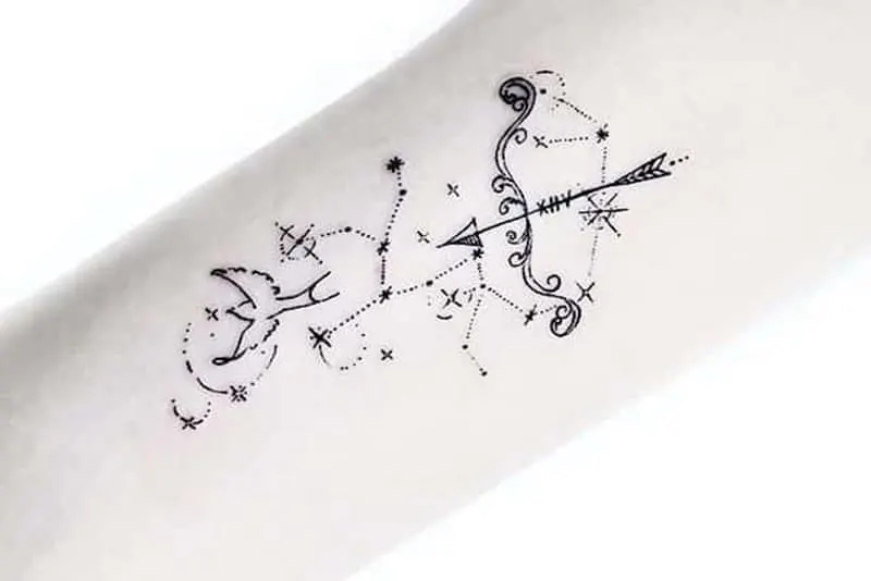a unique small bow and bird tattoo surrounded by the stars
