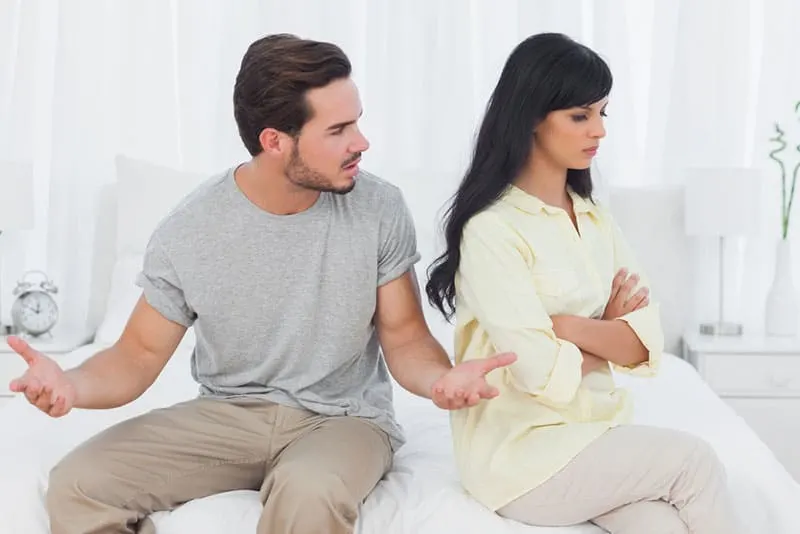 angry man arguing with woman in the bedroom
