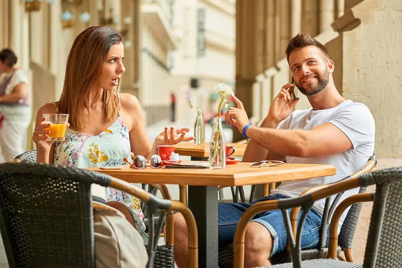 angry woman complaining to man on the phone