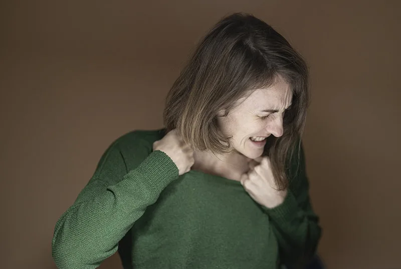 angry woman wearing green sweater