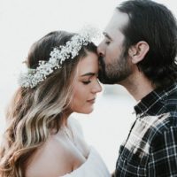 man kisses woman's forehead