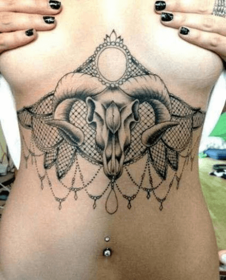 aries ram tattoo under breasts