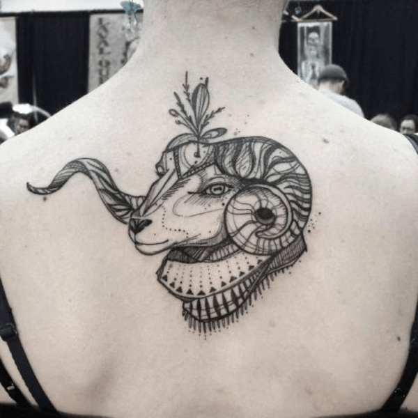 Aries tattoo of a ram’s head on back