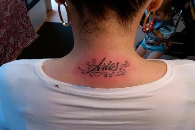 aries text tattoo on the neck