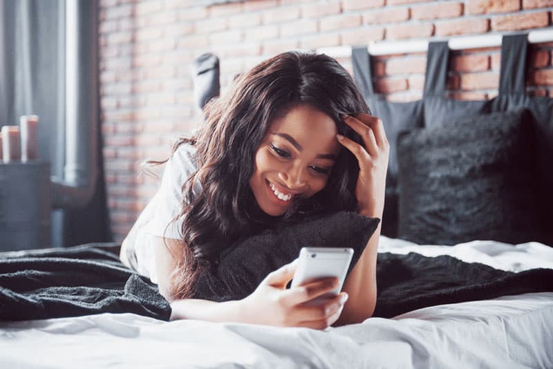 beautiful woman typing on phone