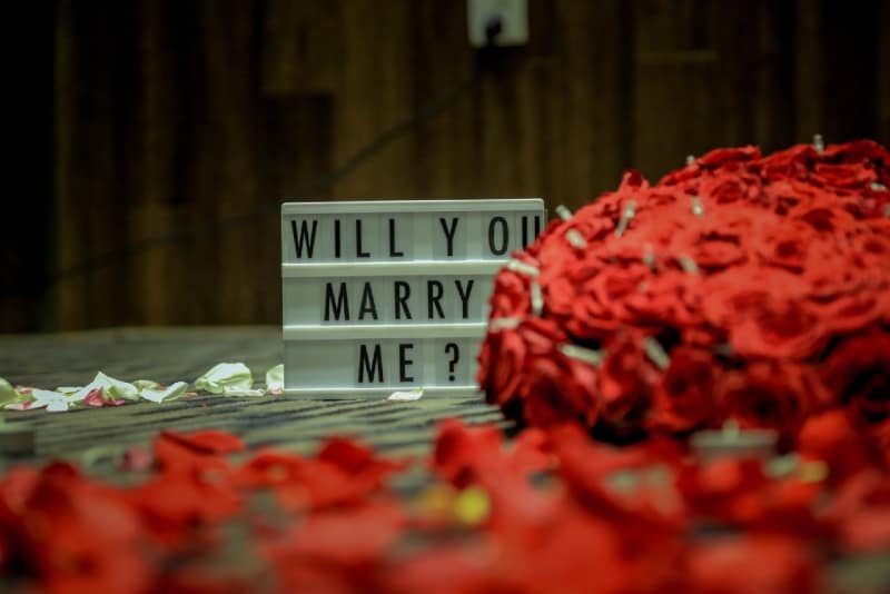 Will you marry me board on brown surface