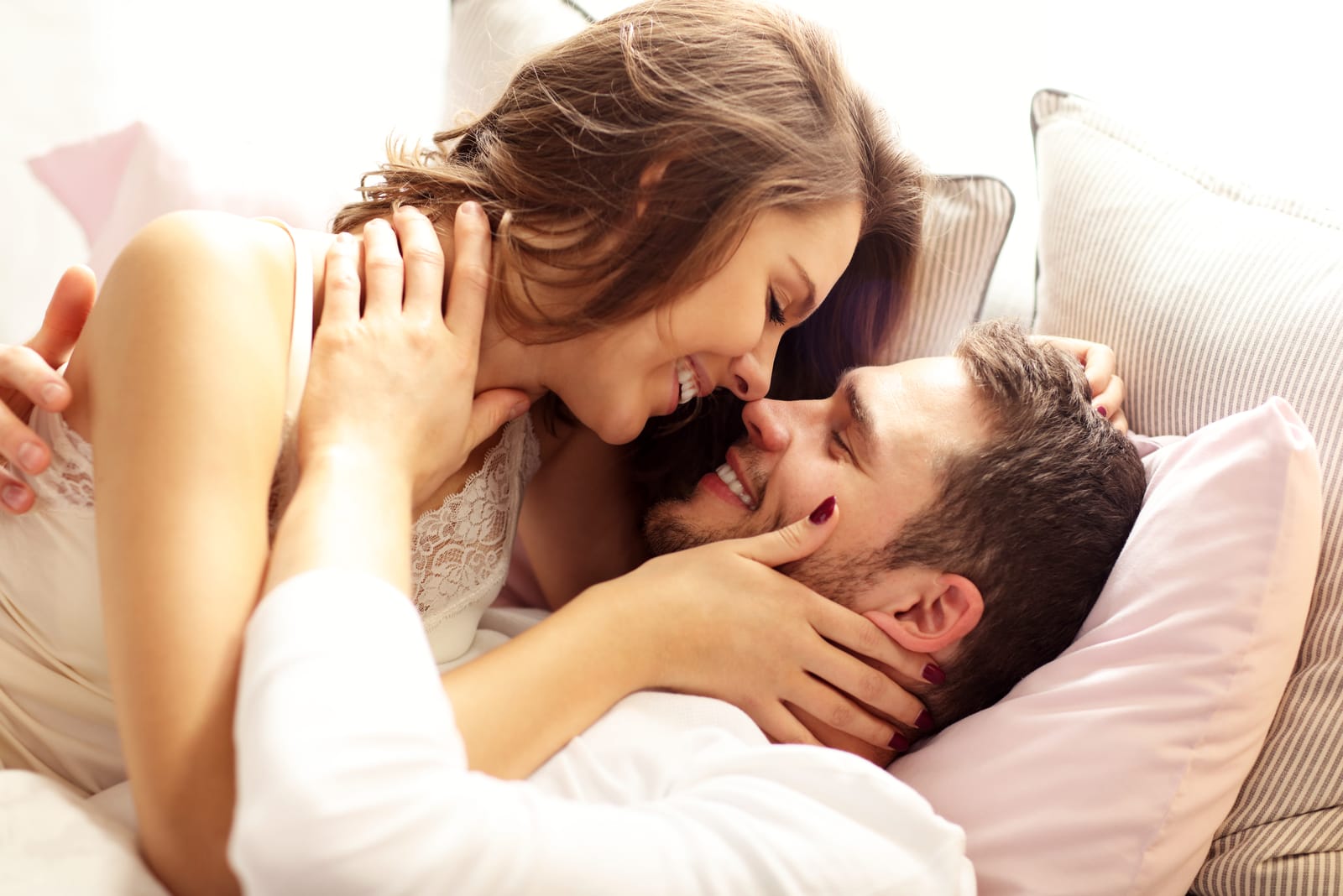 charming couple cuddling in bed and talking