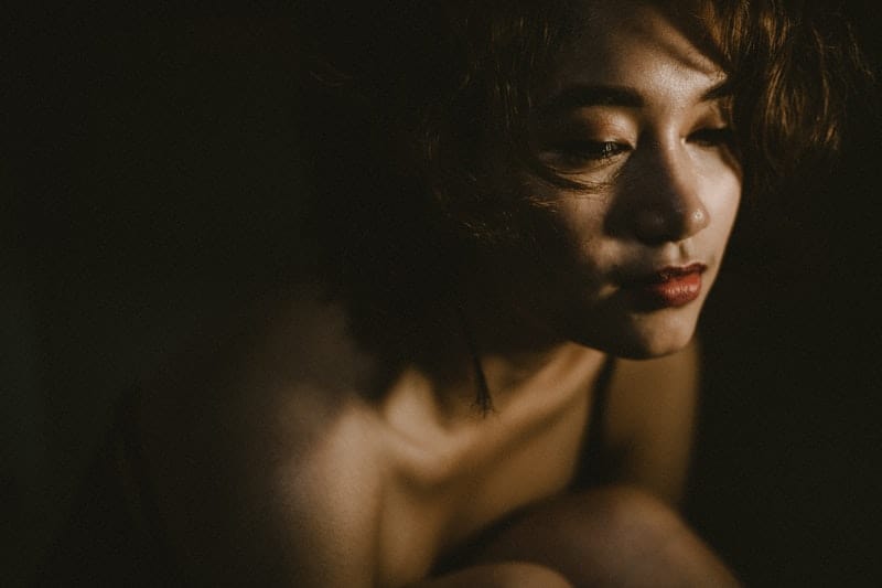 closeup photo of a woman in dark room