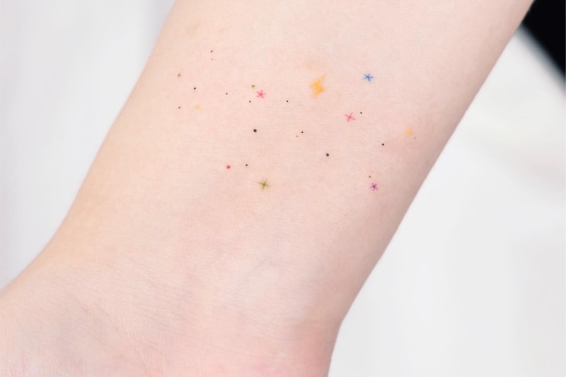 colorful little stars tattoo on the wrist