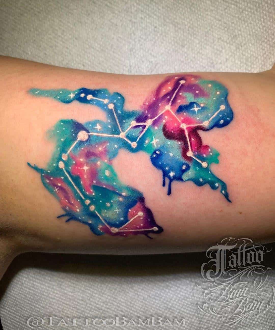 colorful sagittarius constellation tattoo on the arm