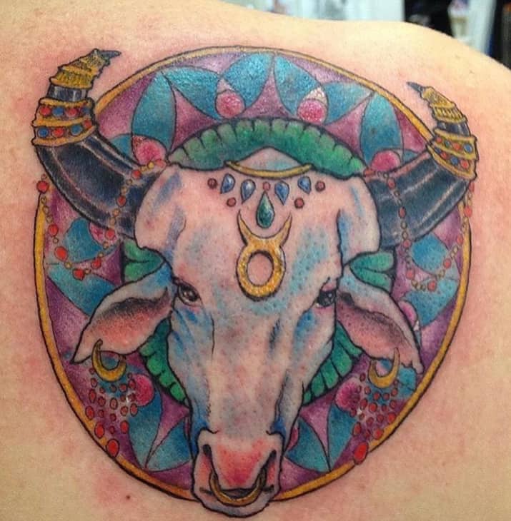 tatuaggio colorato Toro nel cerchio con dettagli in oro