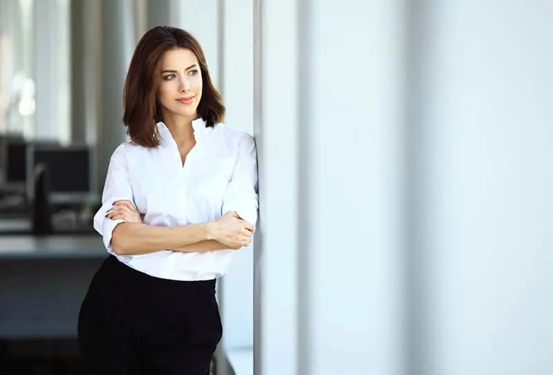 confident business woman standing alone