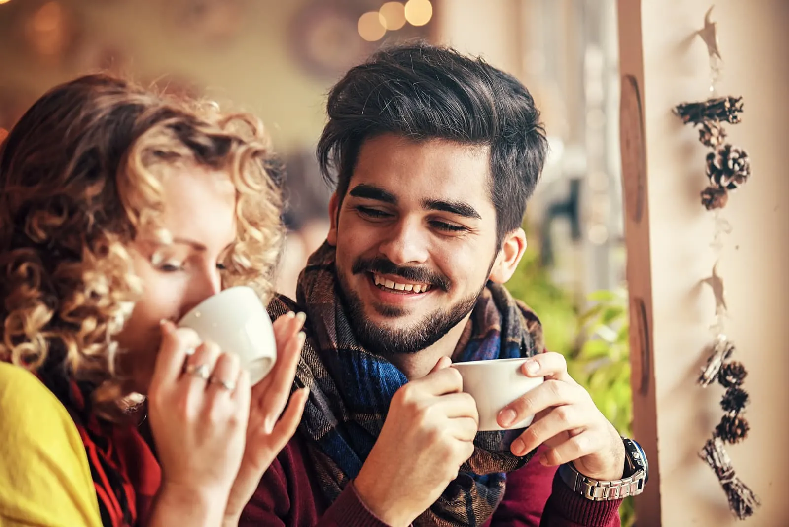 couple sitting in cafe drinking coffee
