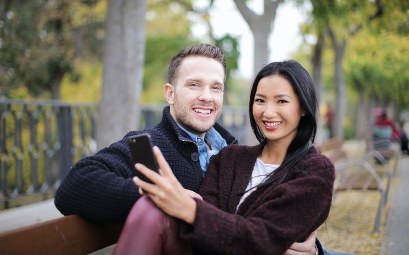 Couple sitting on wooden bench
