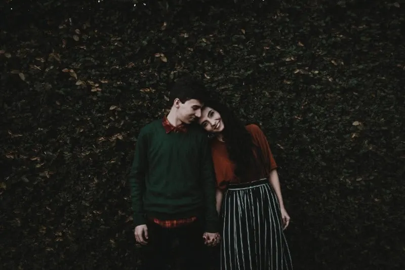 man and woman smiling and holding hands outdoor