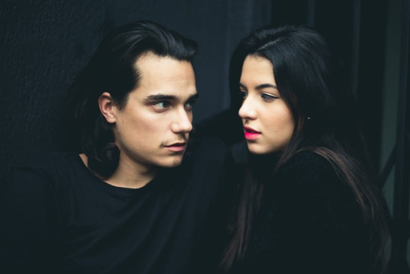 man and woman with red lipstick making eye contact