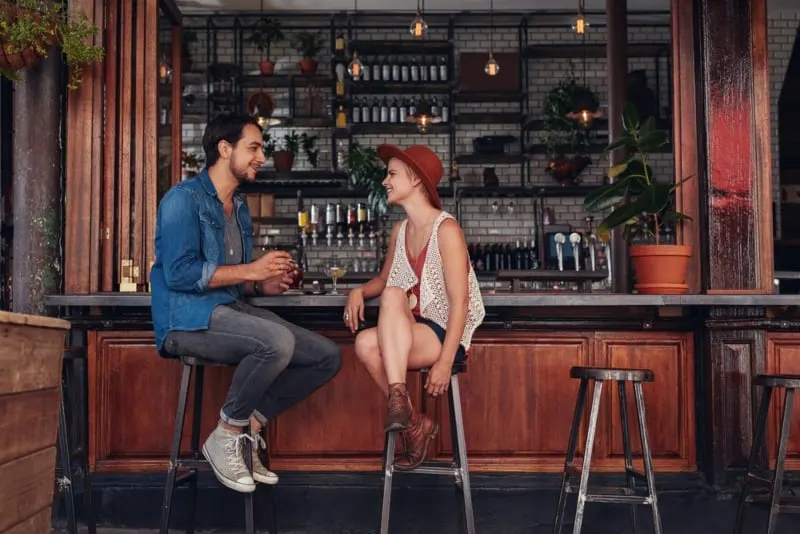 couple talking at bar