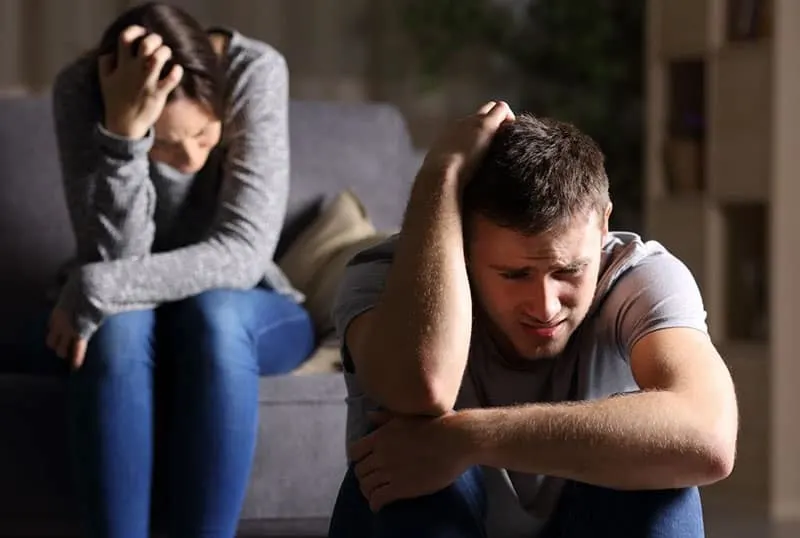 devastated man and woman crying and little distant from each other
