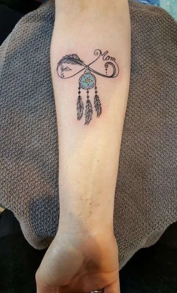 dreamcatcher and feather design tattoo on arm