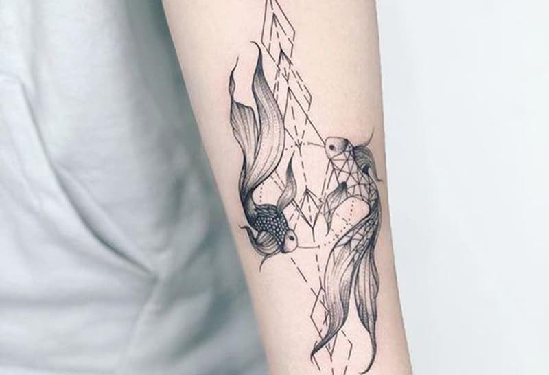 elegant geometric pisces tattoo on the arm