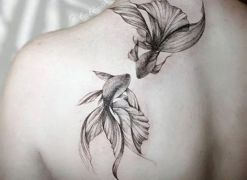 elegant pisces tattoo on the shoulder