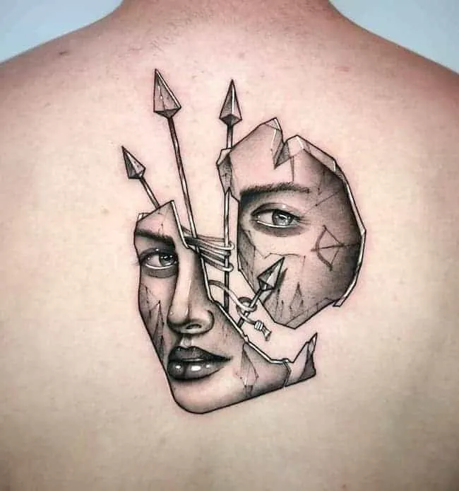 face in pieces tattoo held by the arrows on the back