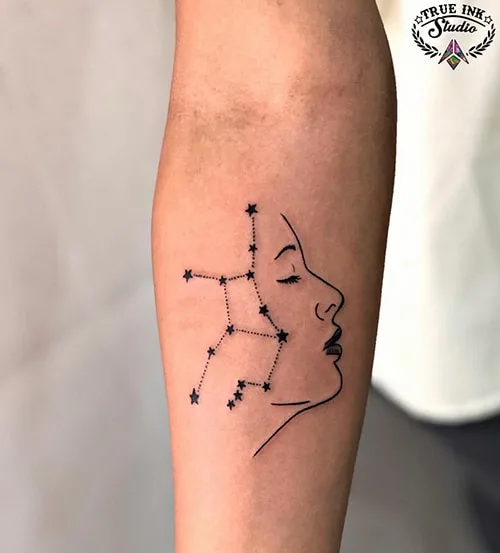 face profile and Virgo constellation with stars tattoo on the forearm