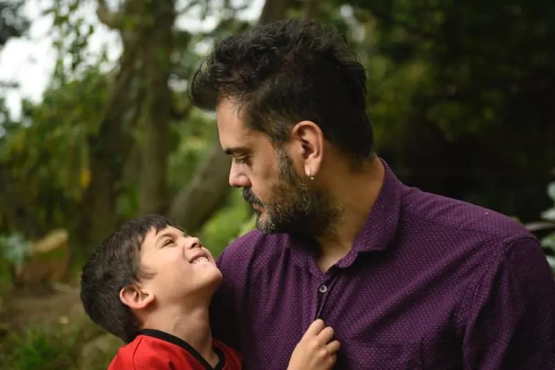 father holding boy
