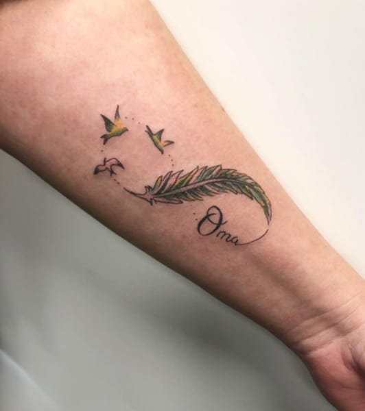 feather infinity tattoo with birds on arm